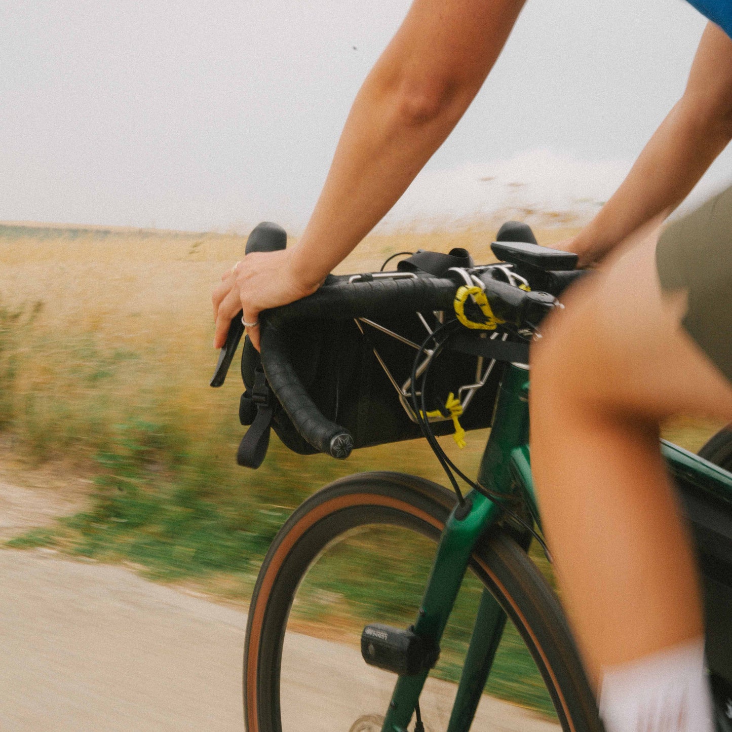 Person riding a bicycle on a path with a blurred background