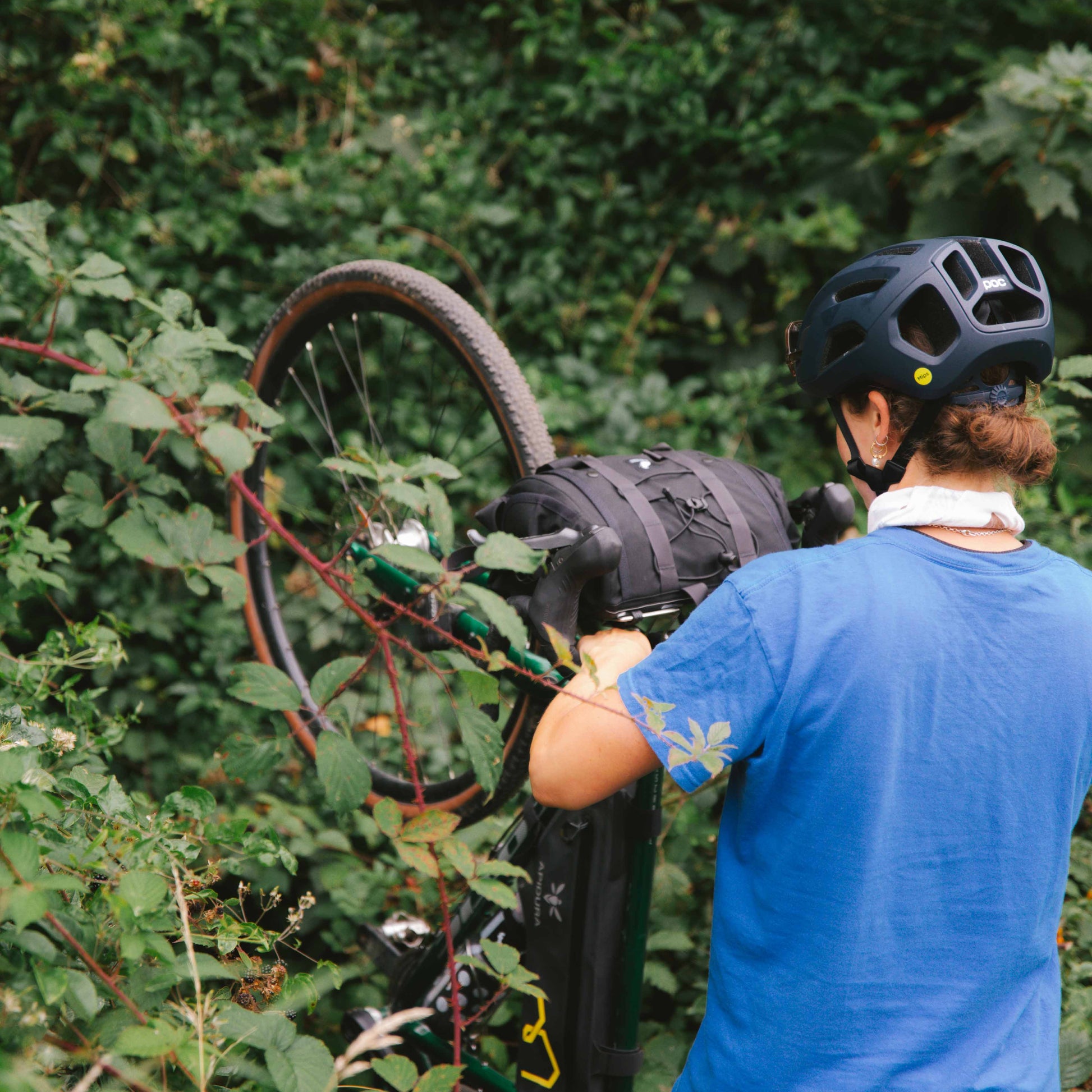 walking a bike through a forest